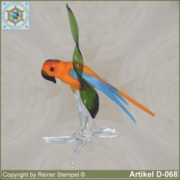Glass animals, glass birds, glass bird parrot on tree oranch orange